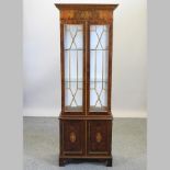 A reproduction glazed display cabinet,