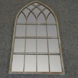 An arched garden wall mirror,