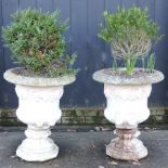 A pair of reconstituted stone garden urns,