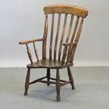 A 19th century elm seated windsor armchair