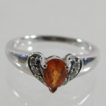 A white gold and mandarin garnet ring,