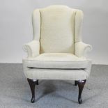 A George III style cream upholstered armchair,