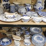 Two shelves of blue and white china, to include jugs and dinner wares,