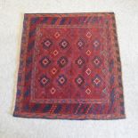 A Turkish woollen rug, with all over medallions, on a red ground,