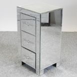A mirrored glass bedside chest,