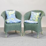 A pair of green painted wicker arm chairs
