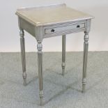 A silver painted occasional table, on fluted legs,