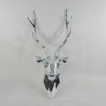 A chrome model of a stag's head,