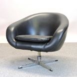 A 1970's black upholstered swivel lounge chair,