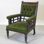 An Edwardian green upholstered armchair