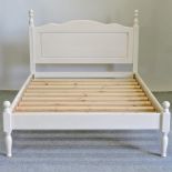 A cream painted pine double bedstead,