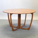 A 1970's teak drop leaf dining table,