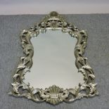 A silver painted rococo style wall mirror,