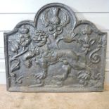 A cast iron fire back, relief decorated with a lion,