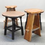 A pair of rustic oak stools, together with a pair of circular copper top tables,