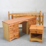 A pine bedside cabinet, together with a pine dressing table and a pine double bedstead,