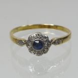 An 18 carat gold sapphire and diamond cluster ring