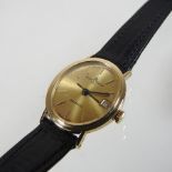An 18 carat gold cased Baume and Mercier ladies automatic wristwatch, on a leather strap,