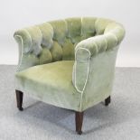 An Edwardian green upholstered button back armchair