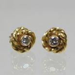 A pair of 18 carat gold diamond earrings,