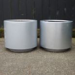 A pair of silver painted garden pots,