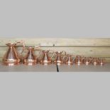 A graduated set of nine 19th century copper measures,