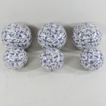 A set of six blue and white ceramic balls,