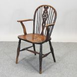 An early 20th century fruitwood wheelback chair