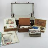 A collection of early 20th century and later postcards and cigarette cards