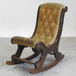 A child's mahogany and brown upholstered rocking chair