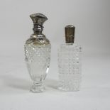 A pair of French cut glass perfume bottles, with engraved white metal lids,