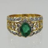 An 18 carat gold emerald and diamond cluster ring,