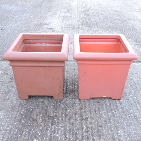 A pair of terracotta style garden pots,