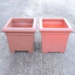 A pair of terracotta style garden pots,
