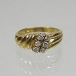 An 18 carat gold diamond six stone ring