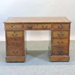 A Victorian oak pedestal writing desk,