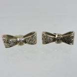 A pair of yellow metal and diamond bow earrings,