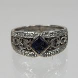 An 18 carat white gold sapphire and diamond ring,