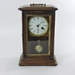 An early 20th century oak cased mantel clock, with a painted dial,