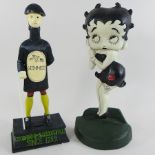A painted metal Betty Boop door stop, together with a Guinness figure,