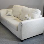 A modern cream upholstered sofa,