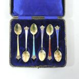 A set of six Norwegian silver gilt and coloured enamel tea spoons,