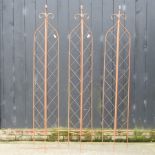 A folding garden lattice spire, together with two others,