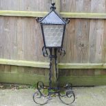 A black painted wrought iron lantern,