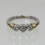 A platinum and diamond three stone collet set ring