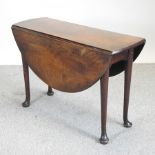 An 18th century mahogany drop leaf dining table, on pad feet,