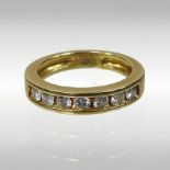 An 18 carat gold seven stone half hoop eternity ring