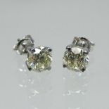 A pair of single stone diamond stud earrings, approximately 2.