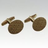 A pair of 9 carat gold cufflinks, each of oval shape, with textured decoration,