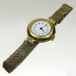 An early 20th century 18 carat gold cased ladies wristwatch, with a white enamelled dial,